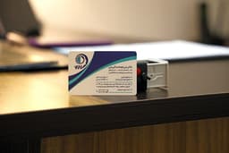 Business card and stamp on a desk — Photo Babak Eshaghian / Unsplash