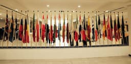 A room with a lot of flags on the wall — Photo Thomas Lohmann / Unsplash