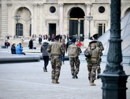 soldiers in green and brown camouflage uniform standing on gray concrete floor during daytime — Photo Fabien Maurin / Unsplash